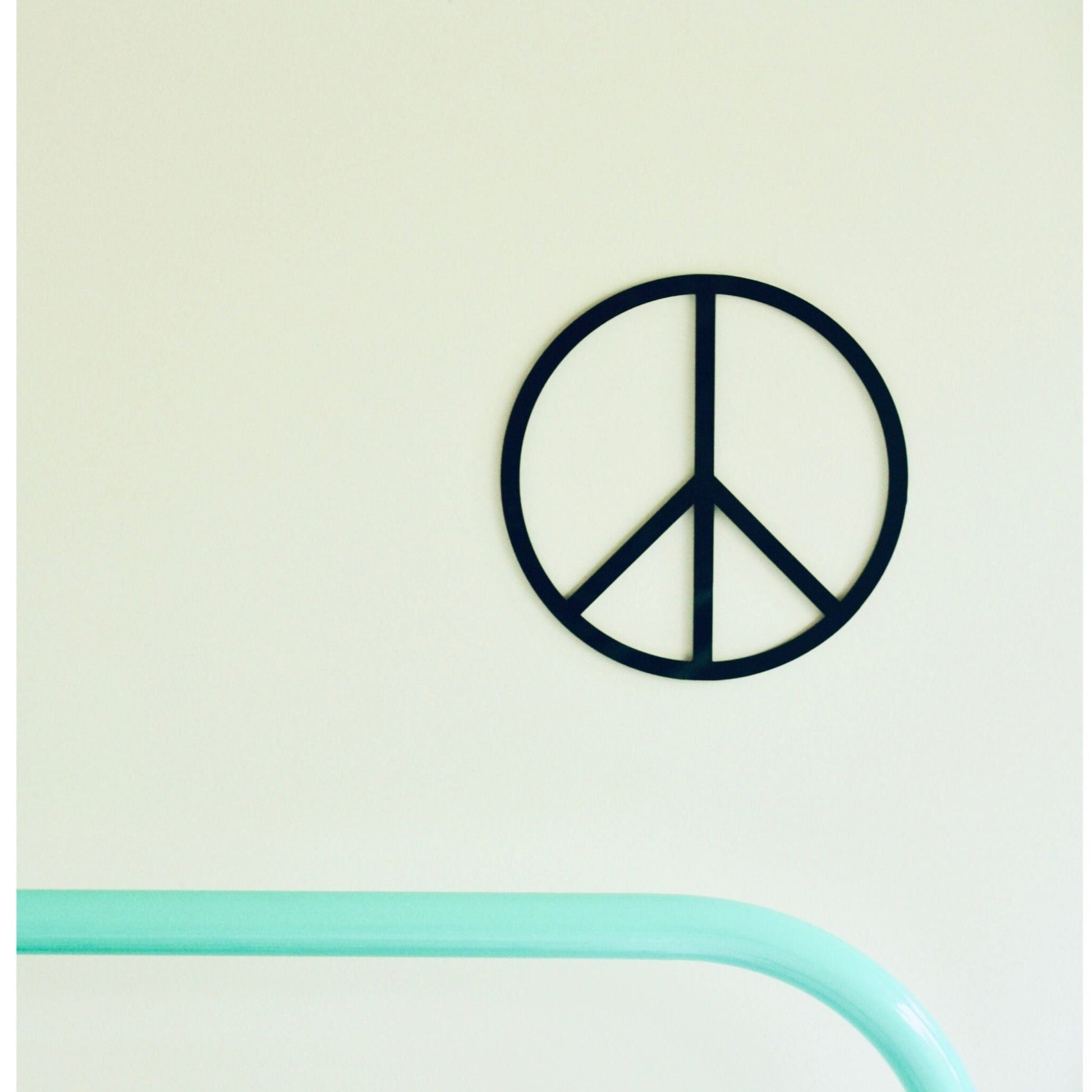 Peace symbol wall art on a light green background