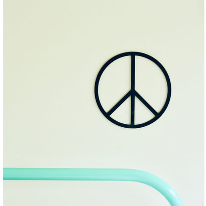 Peace symbol wall art on a light green background