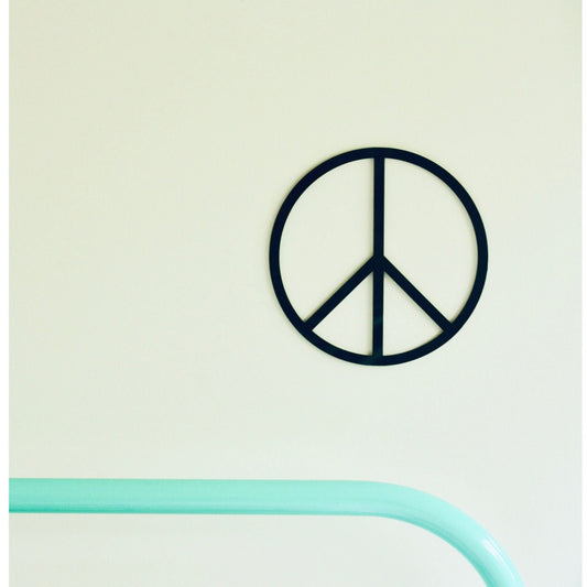 Peace symbol wall art on a light green background